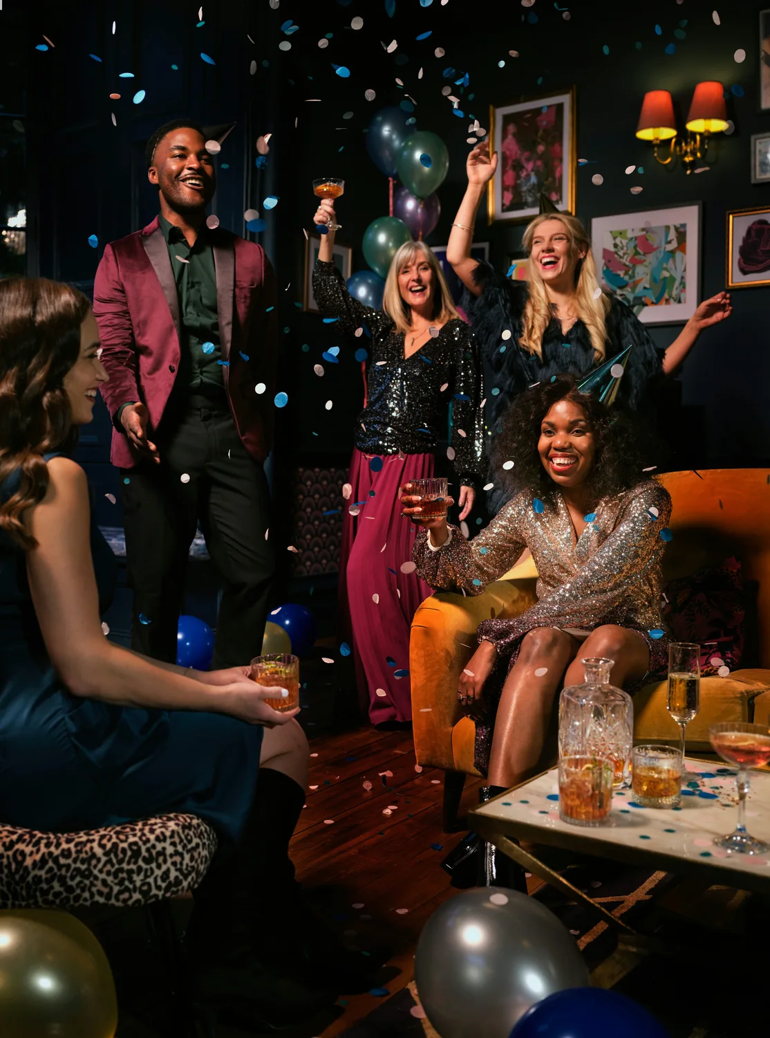 Friends celebrating together as colorful confetti falls