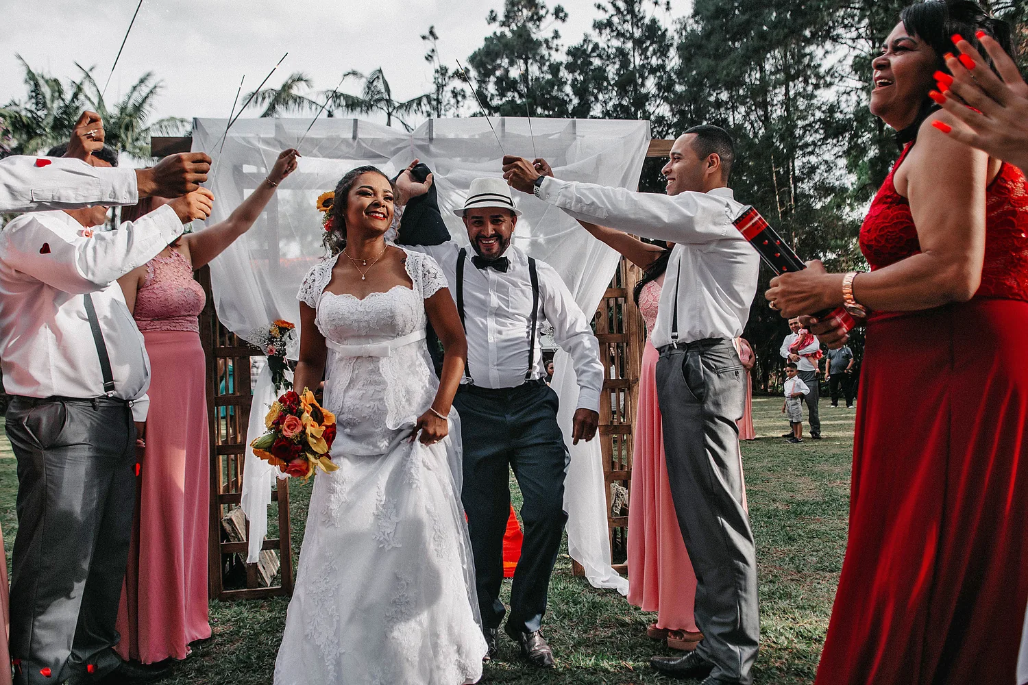 A joyful couple walking through a celebration with friends