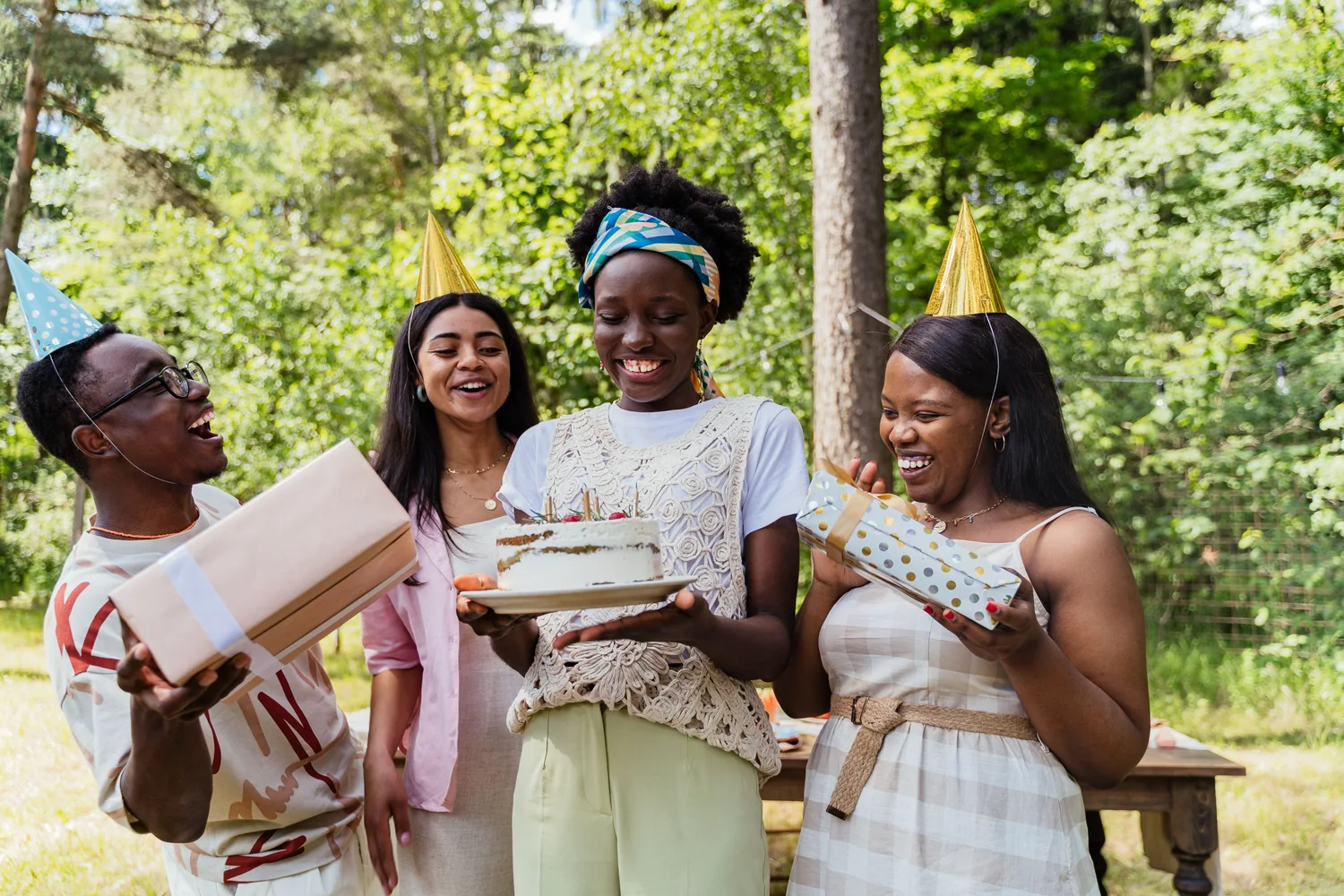 A group of friends celebrating a birthday together outdoors